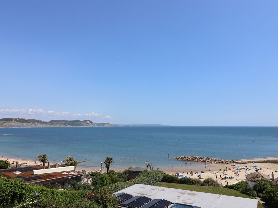 A beach view with people and sea at 3 Harbour Heights Lyme Regis