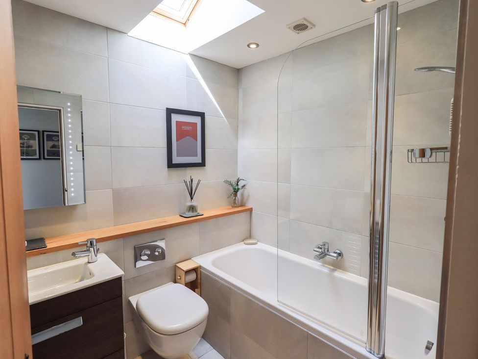 A bathroom with a bathtub and sink at Haystacks in Troutbeck