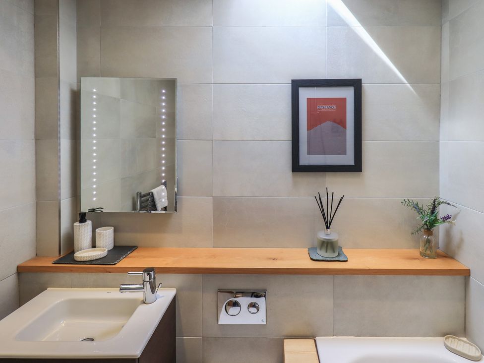 A bathroom with a sink and mirror at Haystacks in Troutbeck