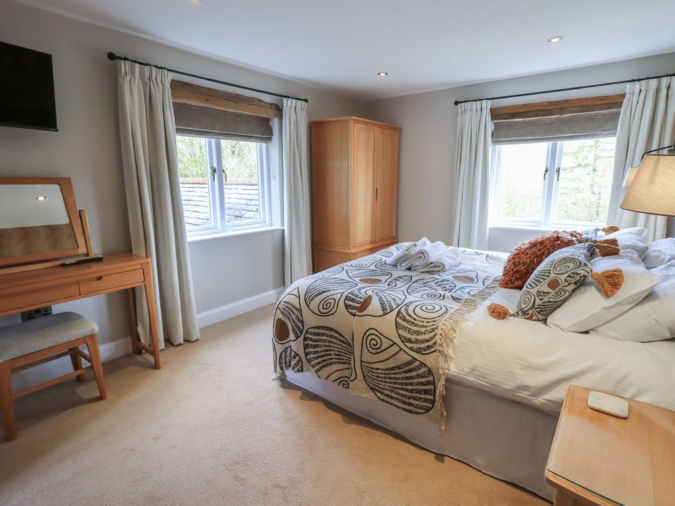 A bedroom with a bed and dresser at Haystacks in Troutbeck