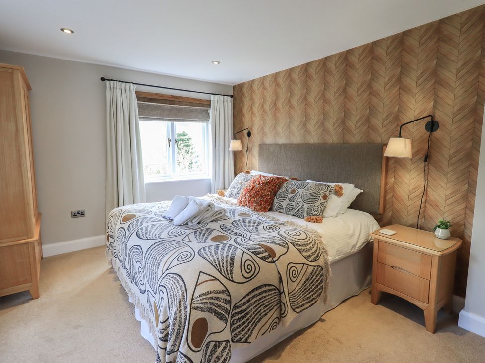 A bedroom with a bed and bedside table at Haystacks in Troutbeck