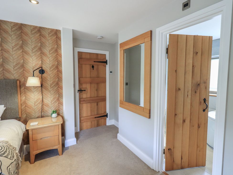 A bedroom with a bed and a side table at Haystacks in Troutbeck