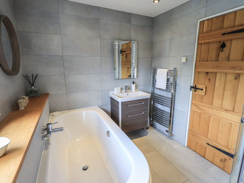 A bathroom with a bathtub and sink at Haystacks in Troutbeck