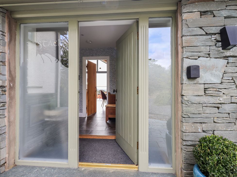 An entrance with a front door and stone walls at Haystacks in Troutbeck