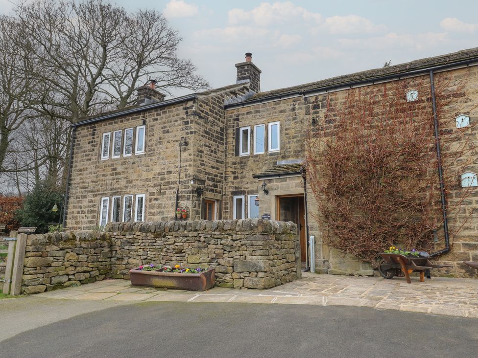A stone house with windows and a door at Barley Cote Farm in Riddlesden