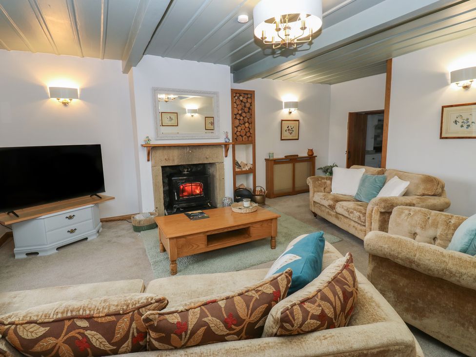 A living room with a television and fireplace at Barley Cote Farm Riddlesden