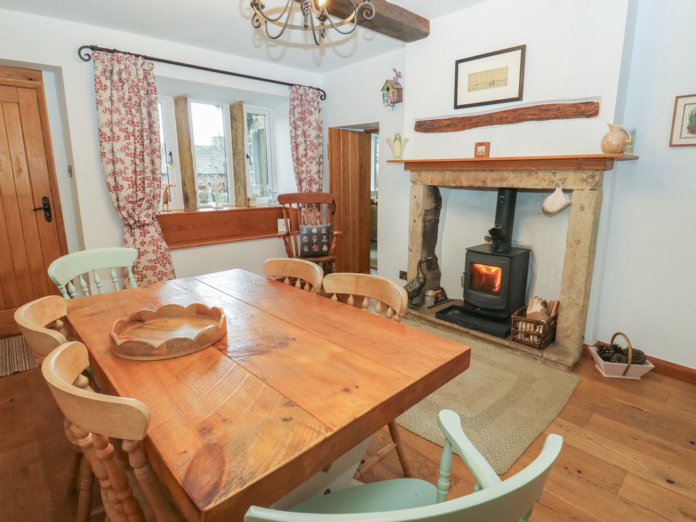 A dining room with a table and chairs at Barley Cote Farm in Riddlesden