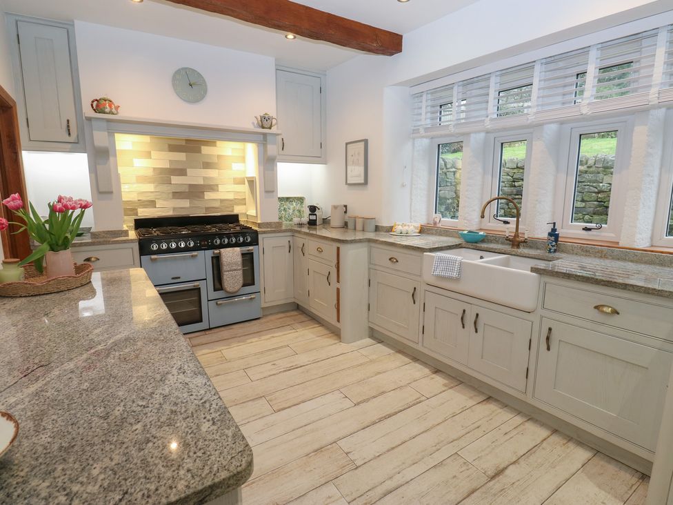 A kitchen with a stove and sink at Barley Cote Farm in Riddlesden