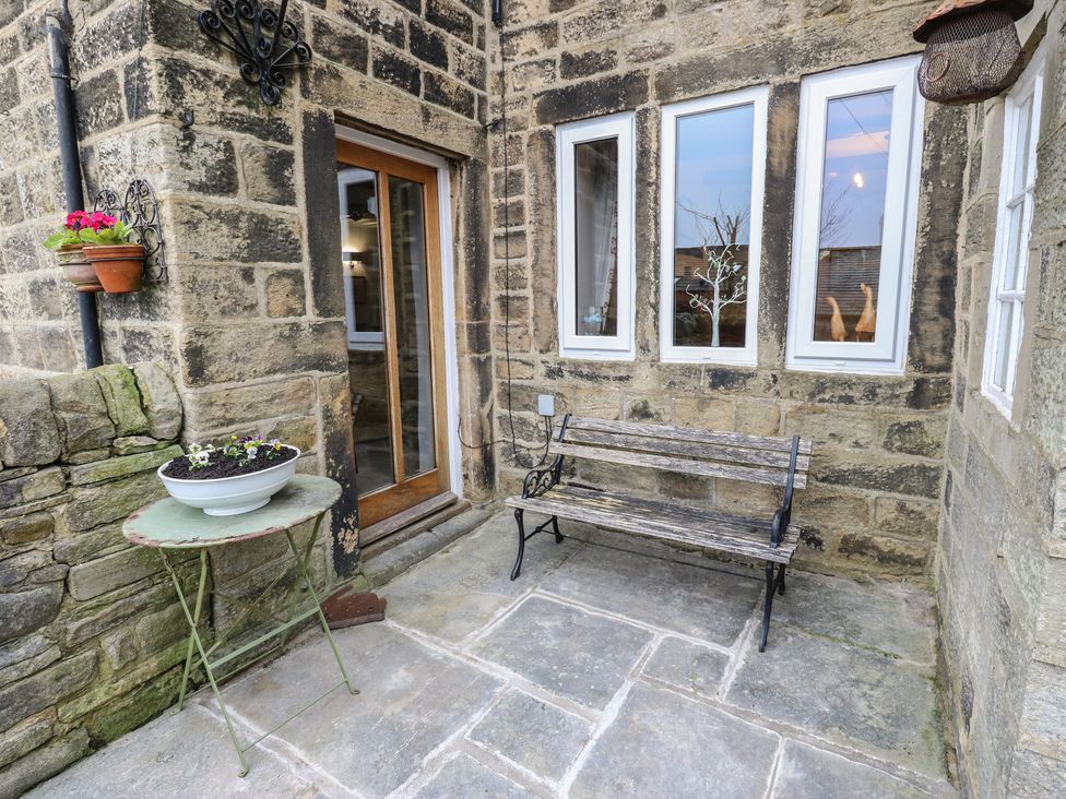 An outdoor area with a bench and a table at Barley Cote Farm in Riddlesden