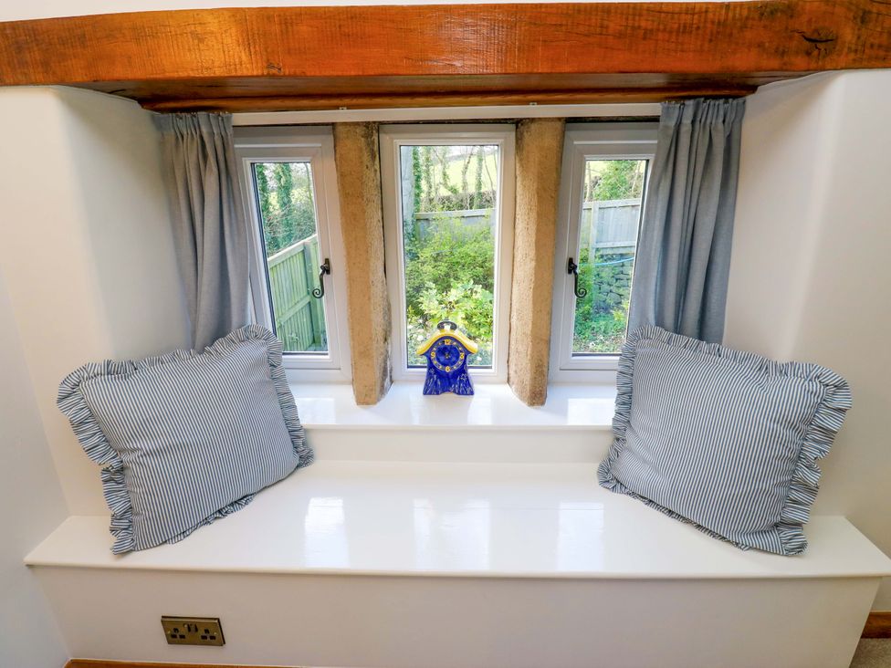 A snug with cushions on a window sill at Barley Cote Farm in Riddlesden