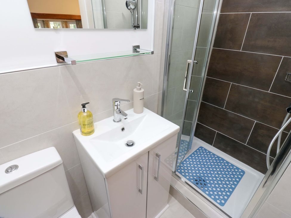 A bathroom with a sink, toilet, and shower at Barley Cote Farm in Riddlesden