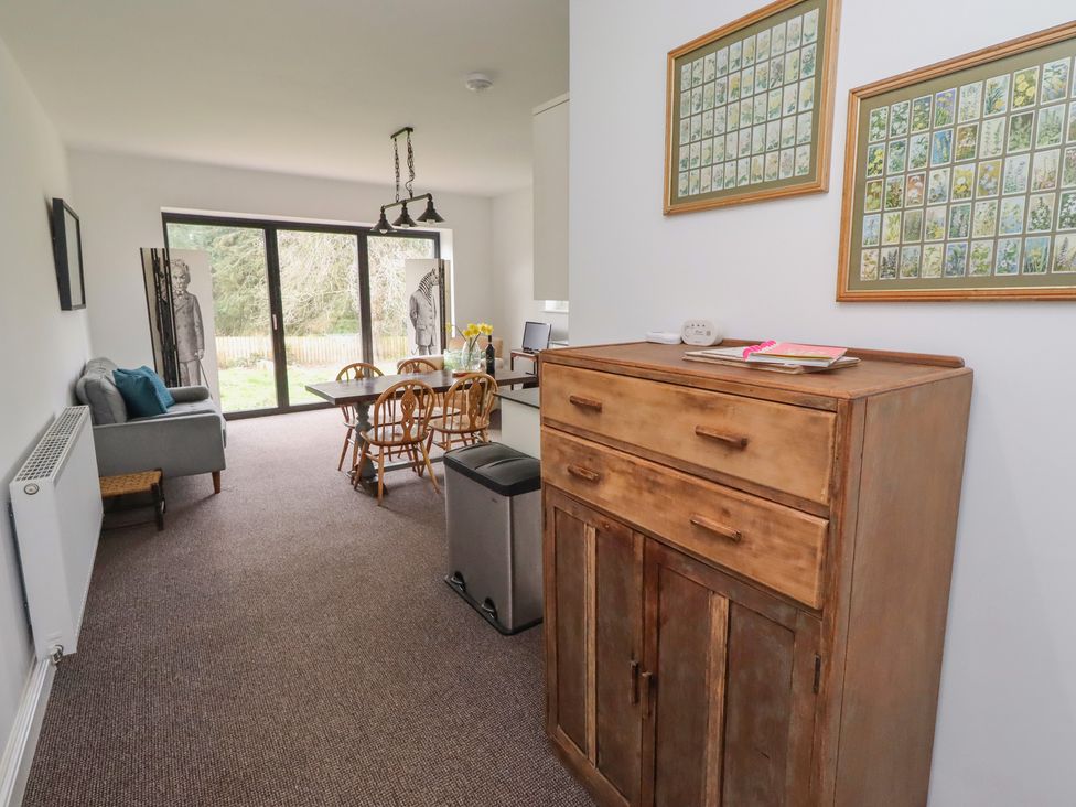 A dining room with a table and chairs at Honeysuckle Cottage in Crookham near Cornhill-On-Tweed