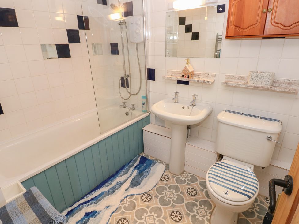 A bathroom featuring a bathtub, sink, and toilet at 2 Strand Cottages in Carmarthen