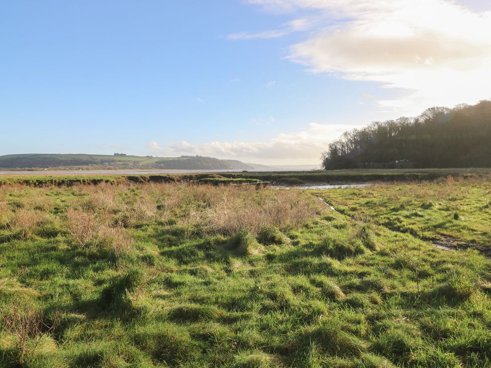 A view of grassland and waterway with hills at 2 Strand Cottages in Carmarthen