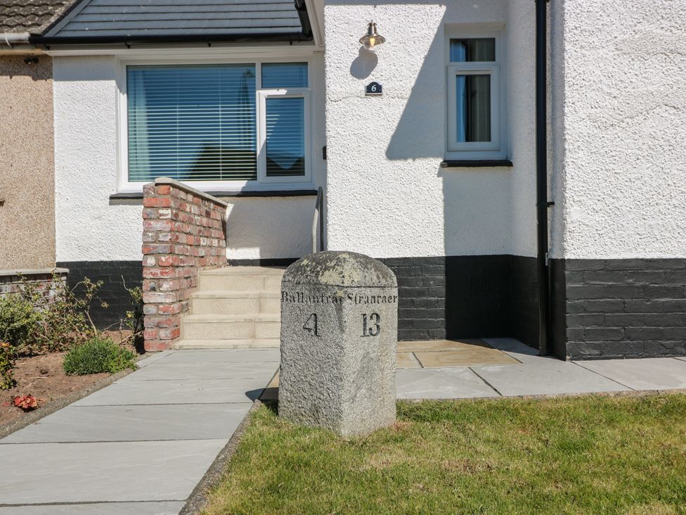 A house entrance with a milestone and steps at Castaway Cottage Maidens