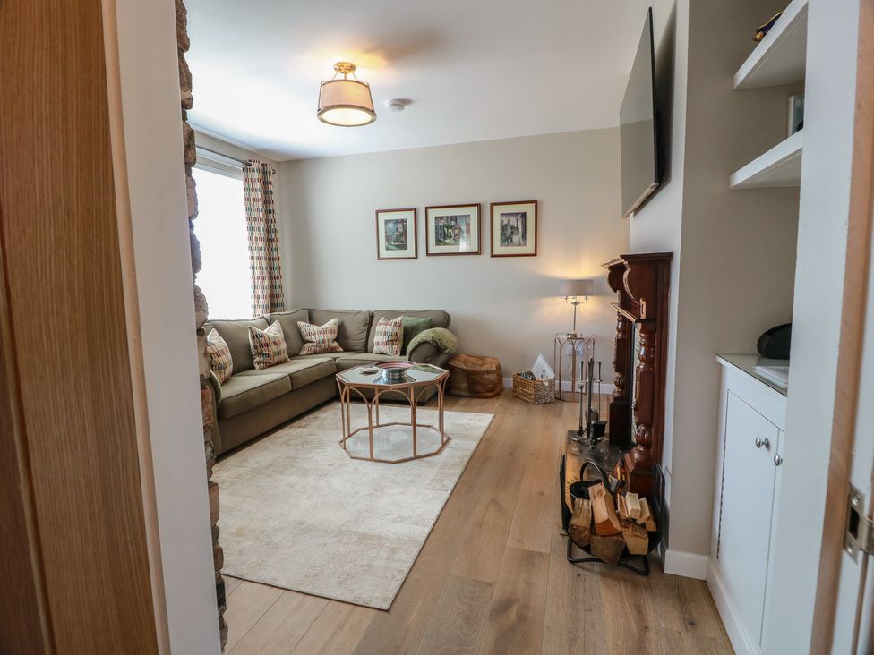 A living room with a sofa and coffee table at Castaway Cottage Maidens