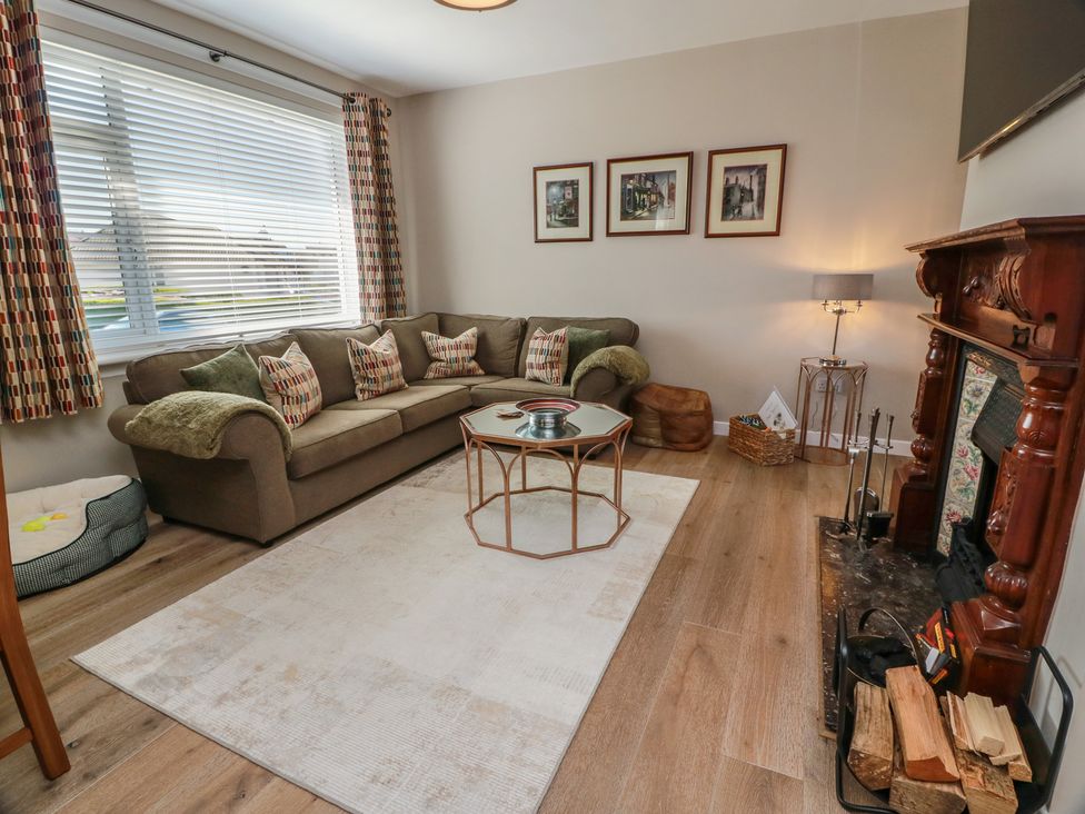 A living room with a sofa and coffee table at Castaway Cottage Maidens