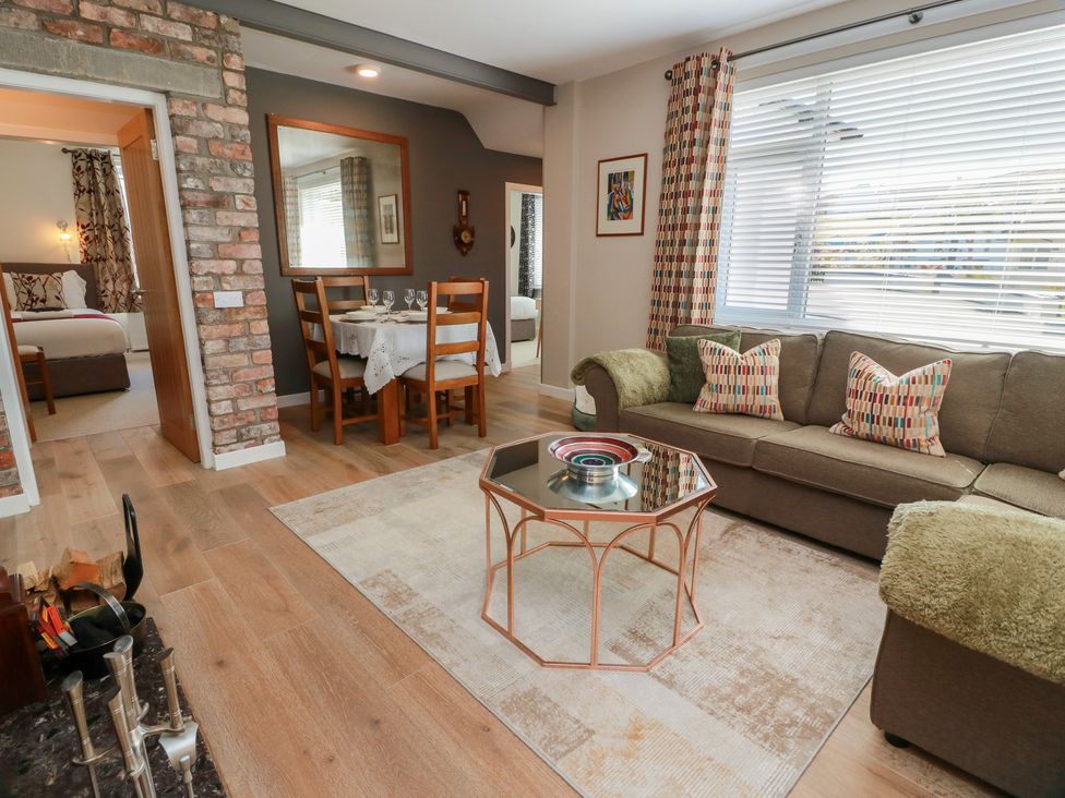 A living room with a sofa and coffee table at Castaway Cottage Maidens