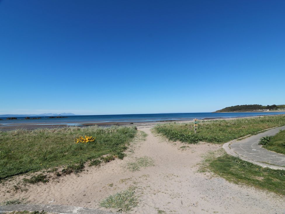 A beach with sand and ocean at Castaway Cottage Maidens