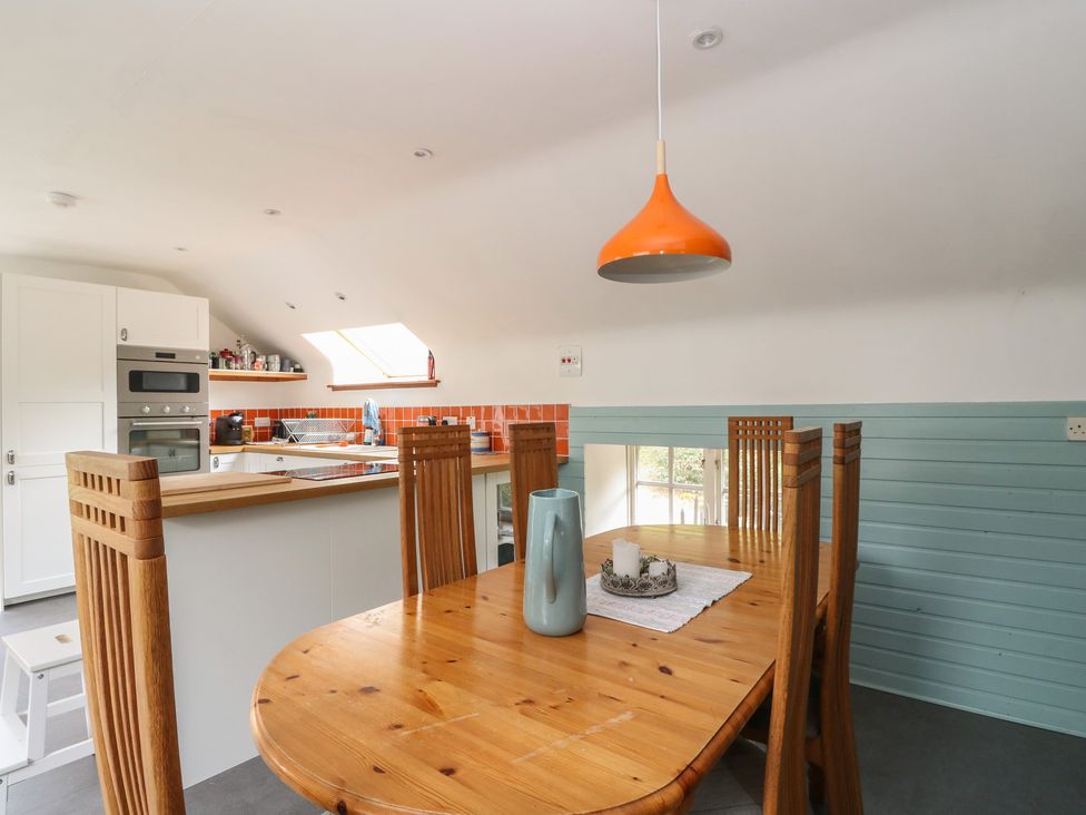 A kitchen with dining area and wooden table at Culearn Mill Balquhidder, Perthshire, Scotland