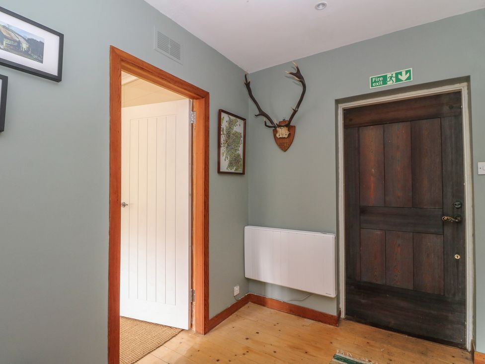 A hallway with a door and radiator at Culearn Mill Balquhidder, Perthshire, Scotland