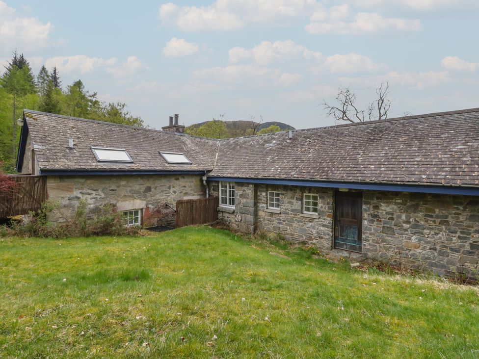 An outdoor view of a stone building with a sloped roof at Culearn Mill, Balquhidder, Perthshire, Scotland