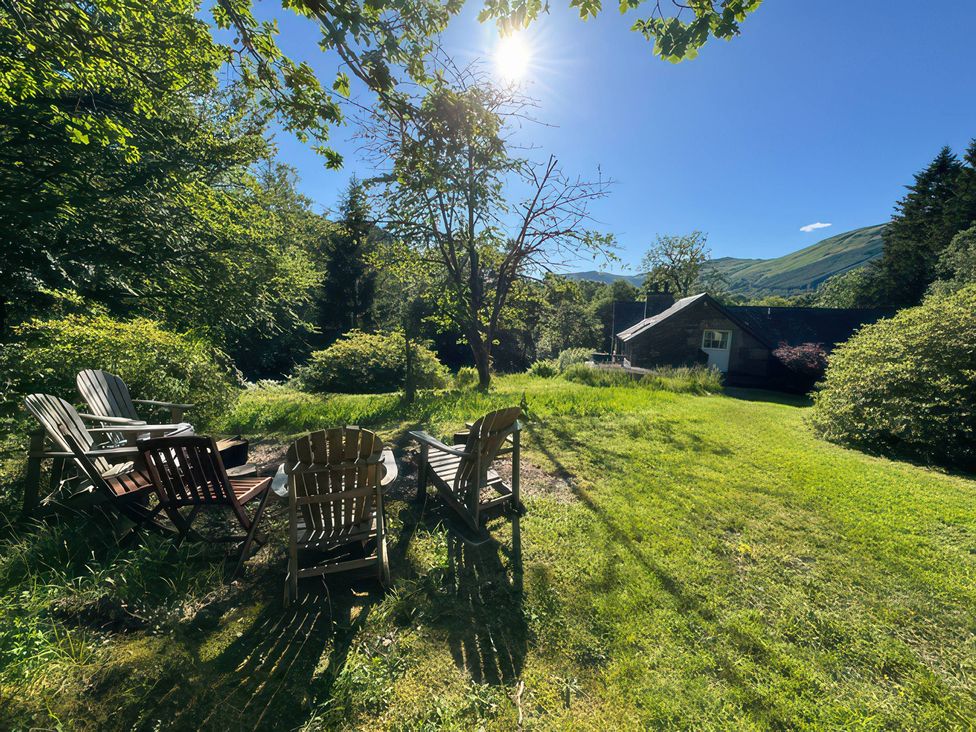 A garden with chairs and a fire pit at Culearn Mill in Balquhidder, Perthshire, Scotland
