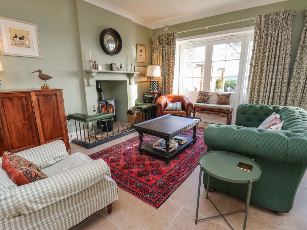 A living room with a fireplace and furniture at Roding Cottage in Egton