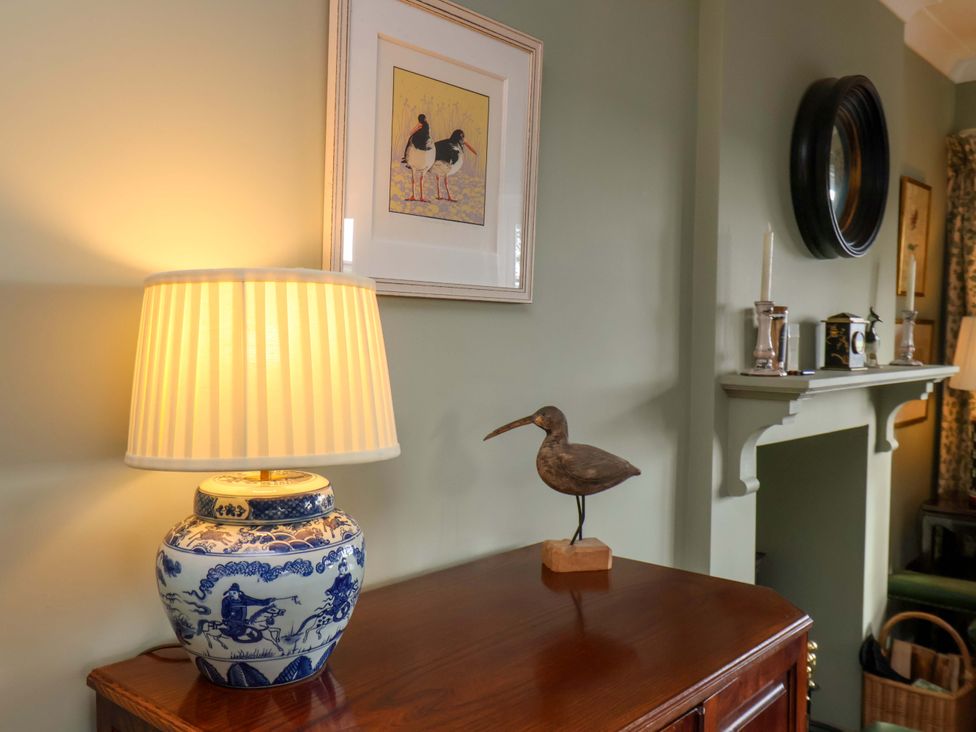 A living room with a lamp and a bird statue at Roding Cottage in Egton