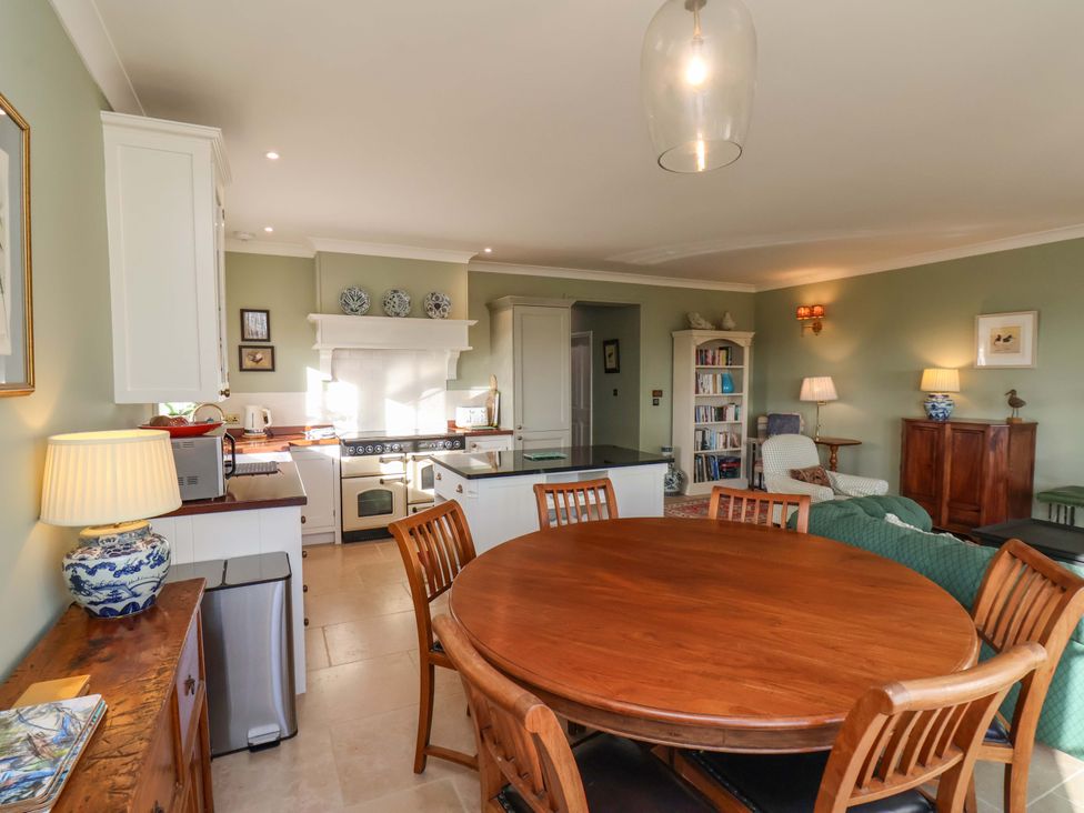 A kitchen with a dining table and chairs at Roding Cottage in Egton