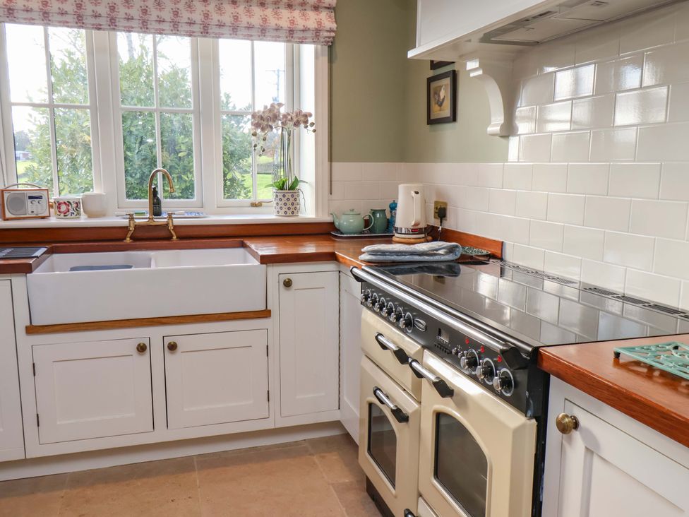 A kitchen with a sink and oven at Roding Cottage in Egton