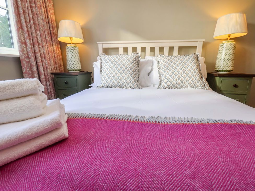 A bedroom with a bed and pillows at Roding Cottage in Egton