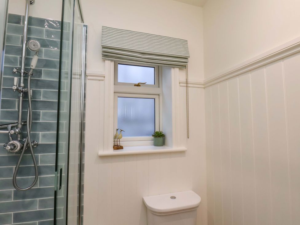 A bathroom with a shower and toilet at Roding Cottage in Egton