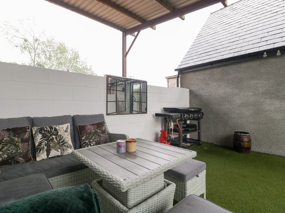 An outdoor patio with seating and a barbecue grill at The Hay Barn in Huntley