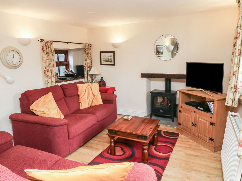 A living room with a sofa and coffee table at Bridge Cottage in Budleigh Salterton