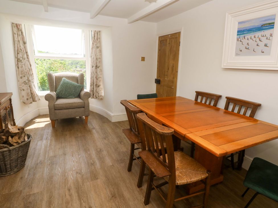 A dining room with a table and chairs at Greenways in Perranporth