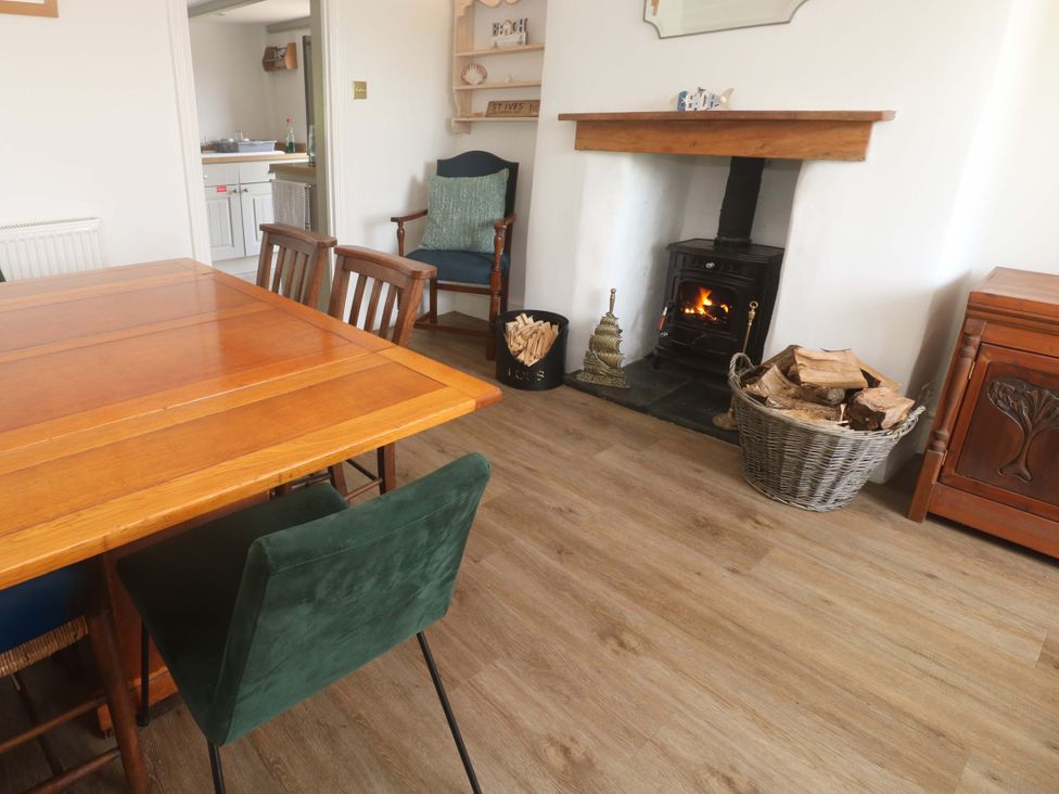A dining room with a table and chairs at Greenways in Perranporth