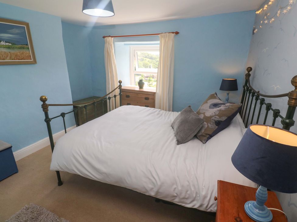 A bedroom with a bed and window at Greenways in Perranporth