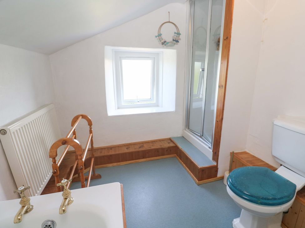 A bathroom with a sink, toilet, and shower at Greenways in Perranporth