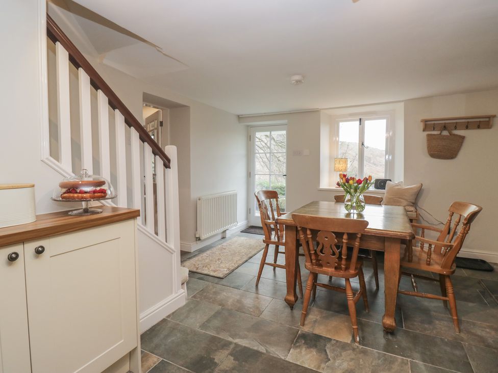 A dining room with a table and chairs at Brockstones Grasmere