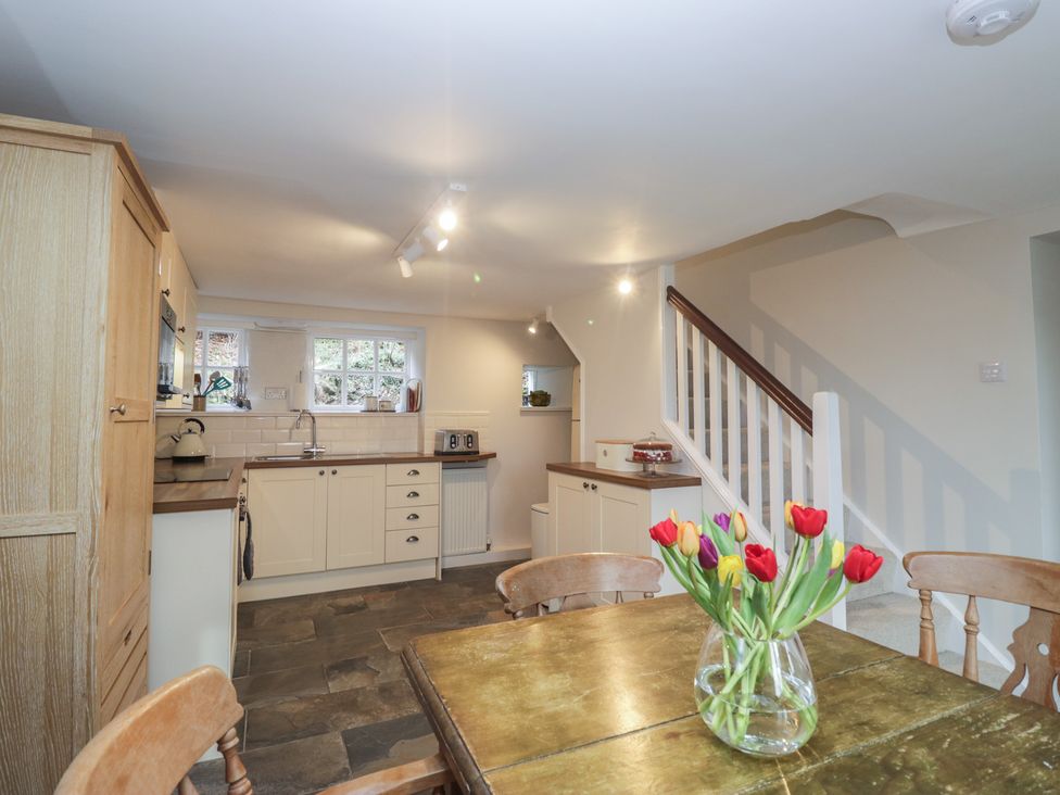 A kitchen with a table and chairs at Brockstones in Grasmere