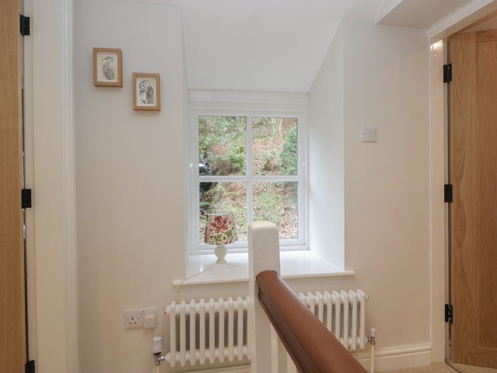 A hallway with a window and radiator at Brockstones in Grasmere