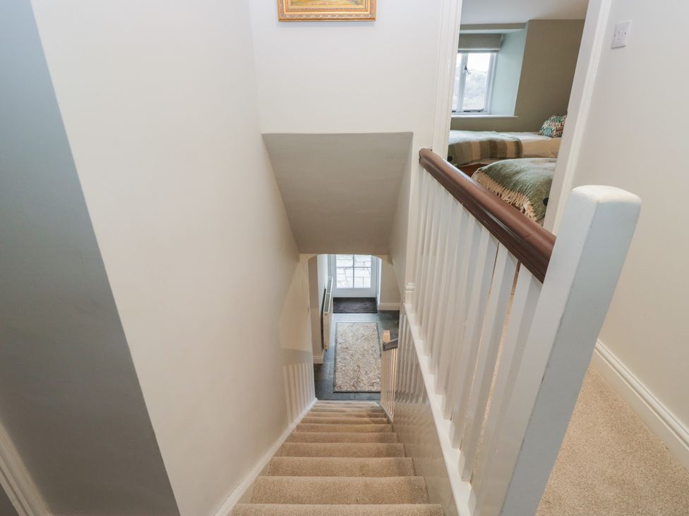 A staircase leading down to a doorway at Brockstones in Grasmere