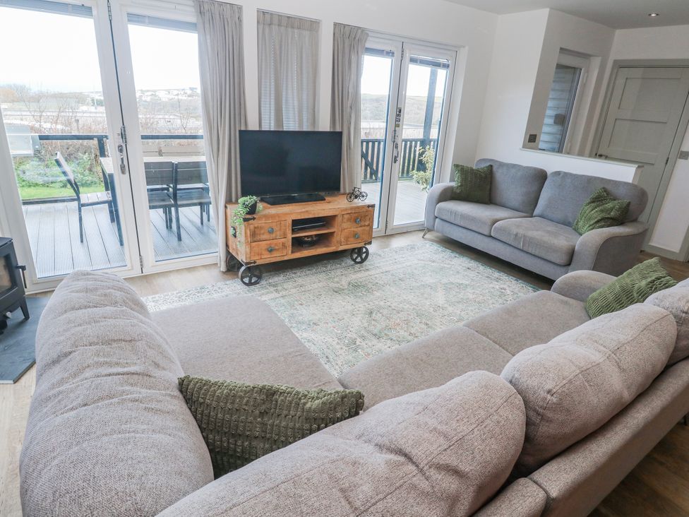 A living room with a television and seating area at Bay View in Portreath