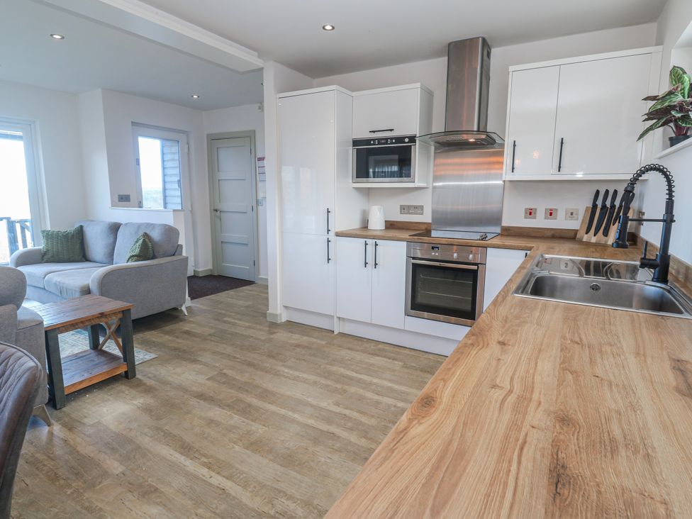 A kitchen with cabinets and appliances at Bay View in Portreath