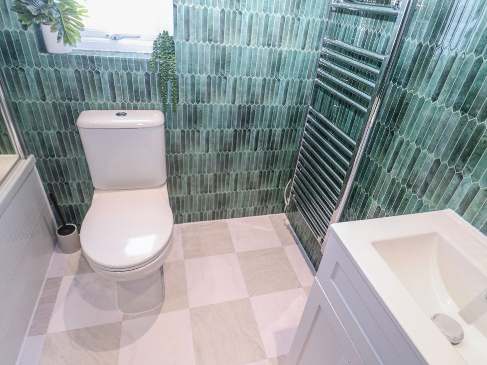 A bathroom with a toilet and sink at Bay View in Portreath