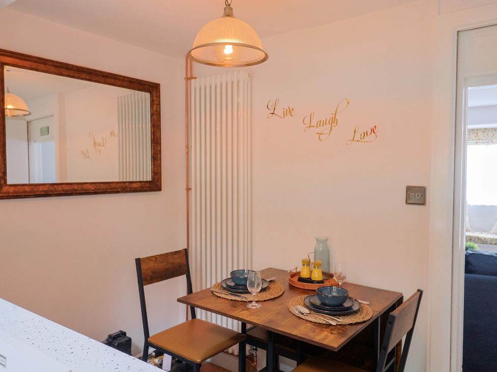A dining room with a table set for two at 6 Bedford Place in Bridport