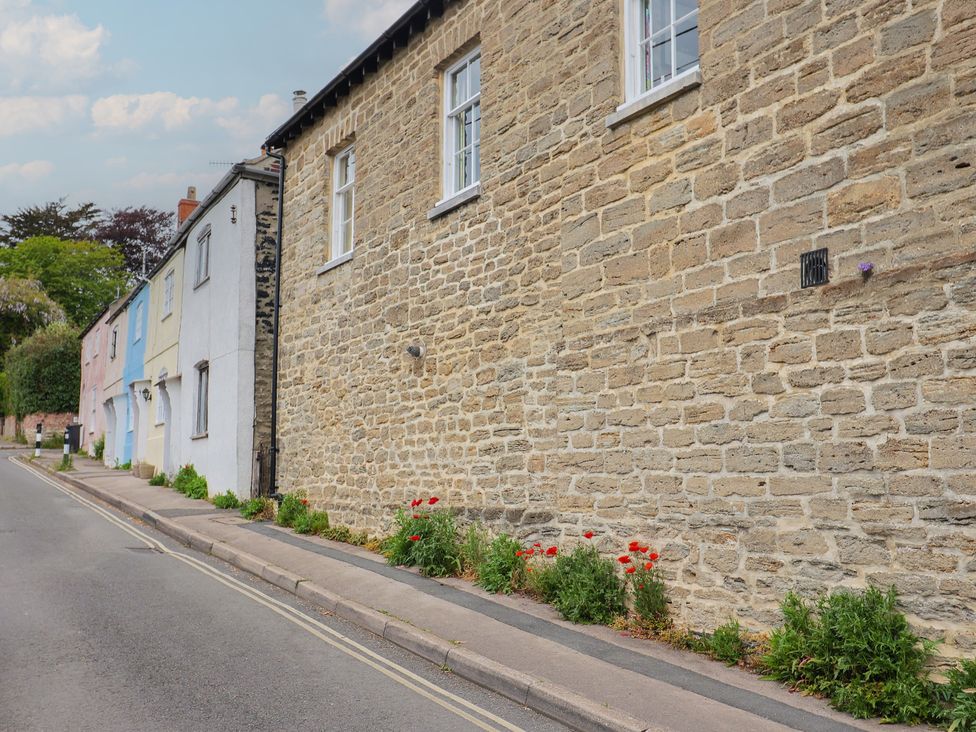 A street view with stone wall and plants at 6 Bedford Place in Bridport