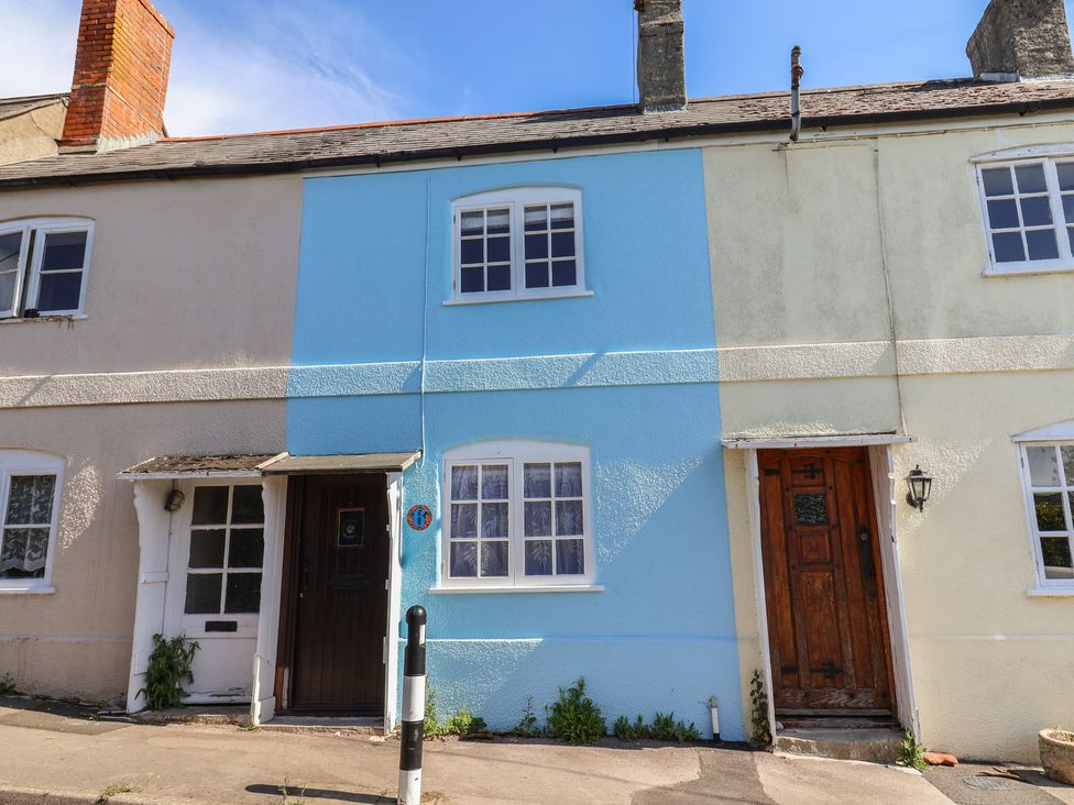 A row of houses with different colored facades at 6 Bedford Place Bridport