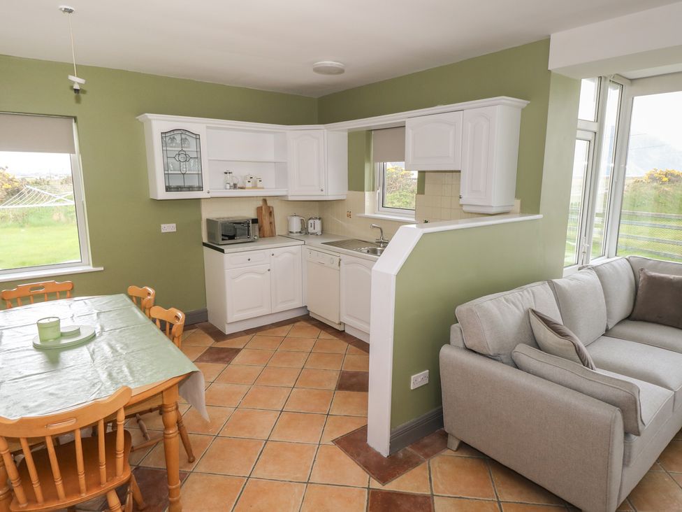A kitchen with dining area and appliances at No.3 Beach Cottages, Keel, County Mayo